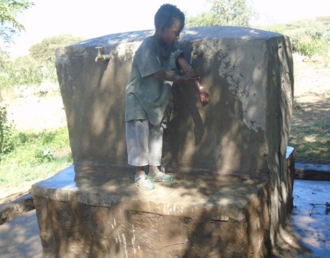 Child utilizing clean water and sanitation facility support